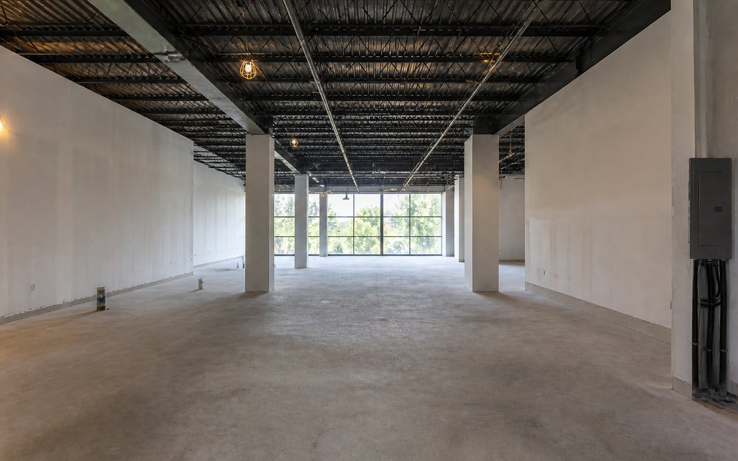 Commercial Tenant Improvements before planning visualization of the same space: A vacant white-box suite shows the base-building, proposed-use, utility, approval, and layout questions to resolve.