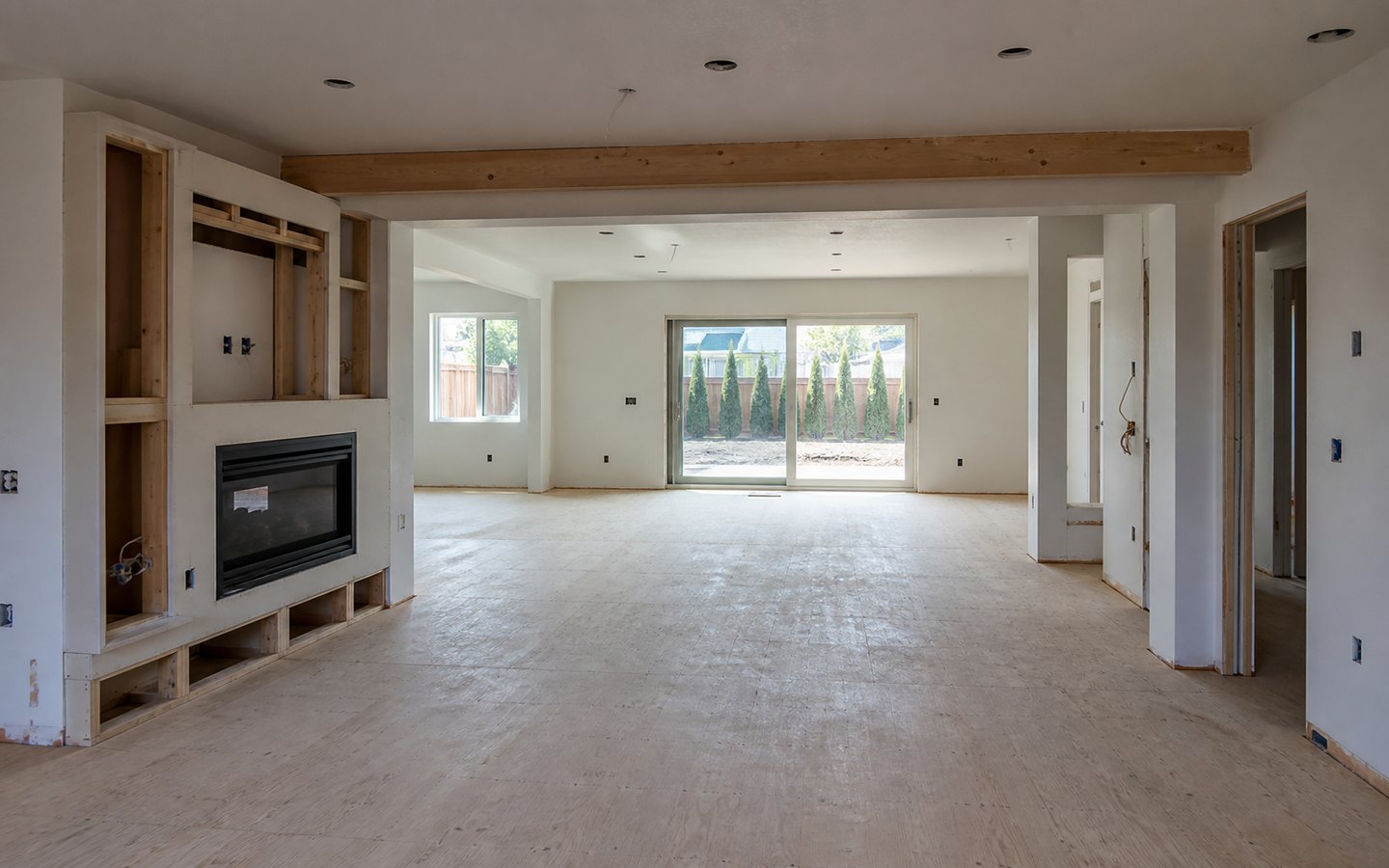 Home Remodeling during planning visualization of the same space: The removed divider, widened opening, fireplace, niches, and electrical rough-ins establish the redesigned open plan.
