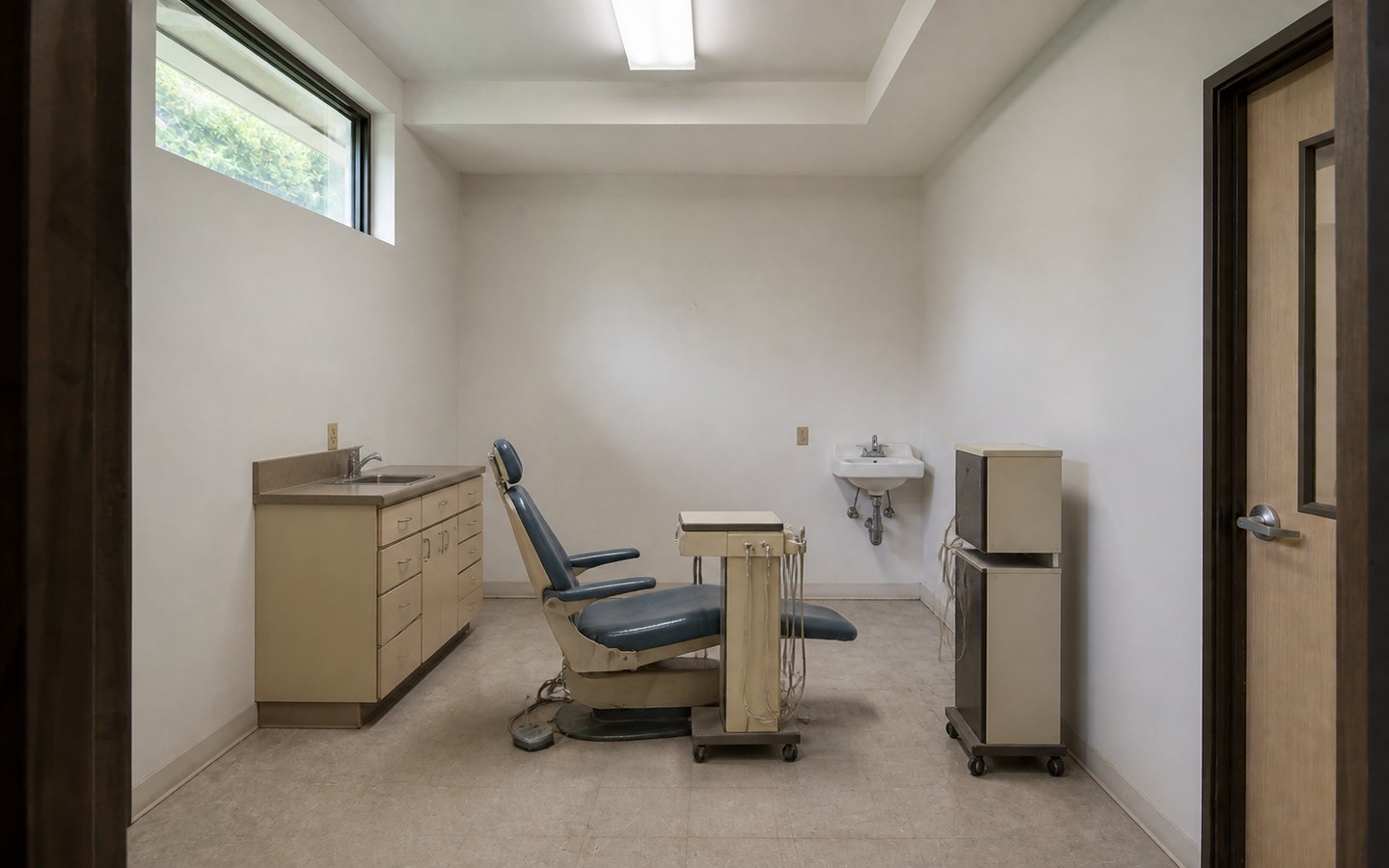 Medical and Dental Office Remodeling before planning visualization of the same space: A dated dental treatment room reveals patient flow, casework, equipment, sink, lighting, and building-system constraints.