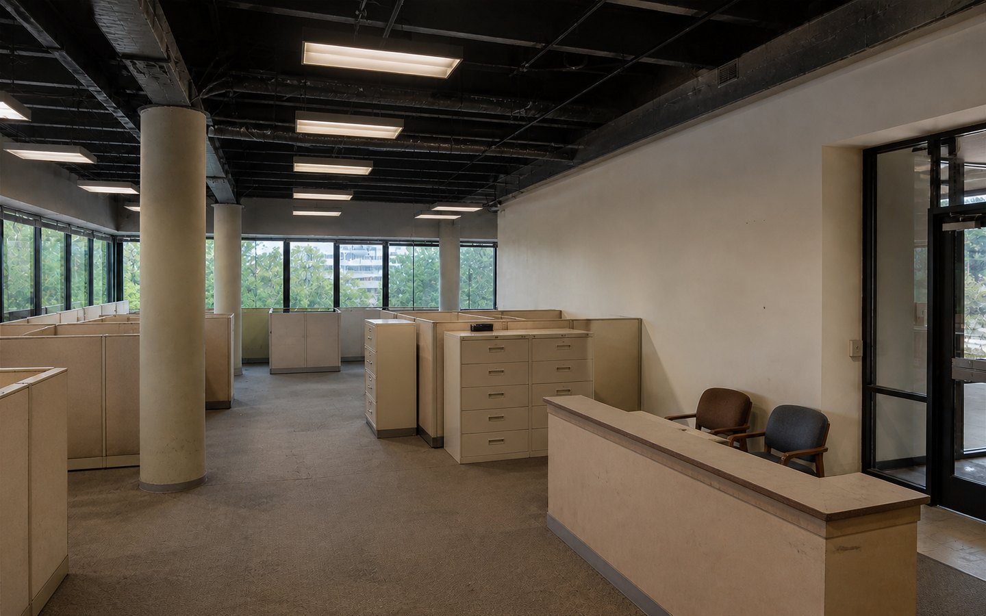 Office Remodeling before planning visualization of the same space: A dated cubicle office exposes daylight, circulation, acoustic, collaboration, reception, and power-distribution needs.