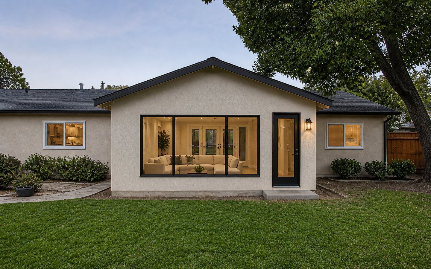 Room Additions after planning visualization of the same space: The finished room keeps that exact footprint, roof, garden opening, side door, and house connection while completing the exterior and interior finishes.