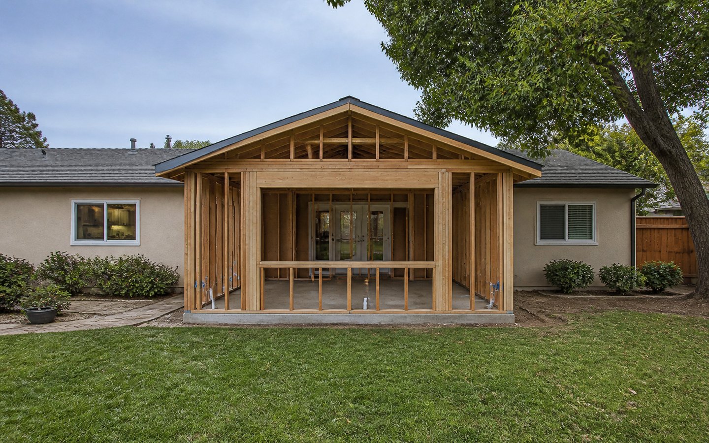 Room Additions during planning visualization of the same space: The new slab, framing, roof tie-in, garden opening, side door, and house connection establish the addition geometry.