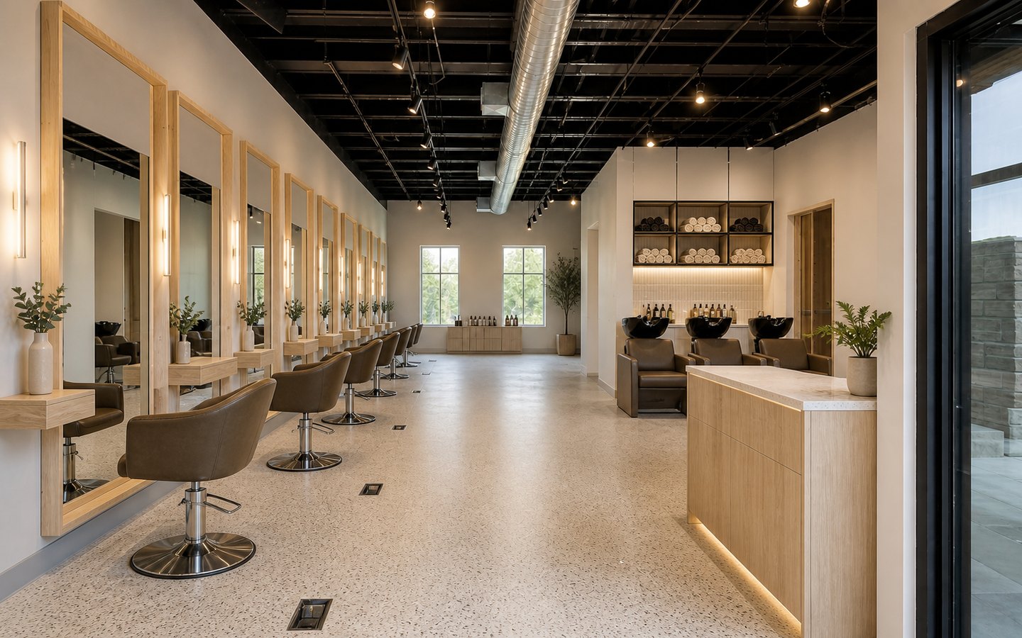 Salon and Spa Remodeling after planning visualization of the same space: The finished salon keeps that exact station, shampoo, aisle, reception, mirror, and lighting geometry while completing durable guest-ready finishes.